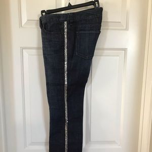 Woman’s Jeans size 4 with silver shiny stripe on both sides.